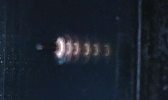 A bullet's energy being dispersed by the layers of ballistic glass