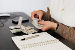 A woman counting a handful of cash